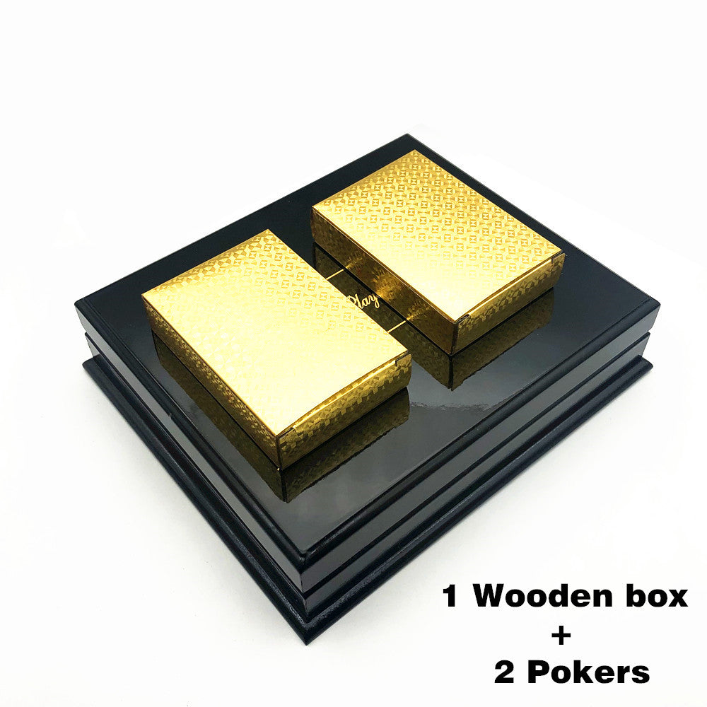 Two deck golden playing cards on a wooden box