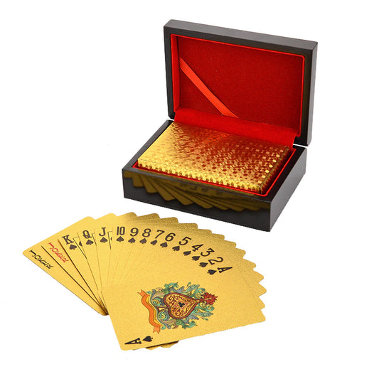Golden foiled poker playing cards with a wooden box